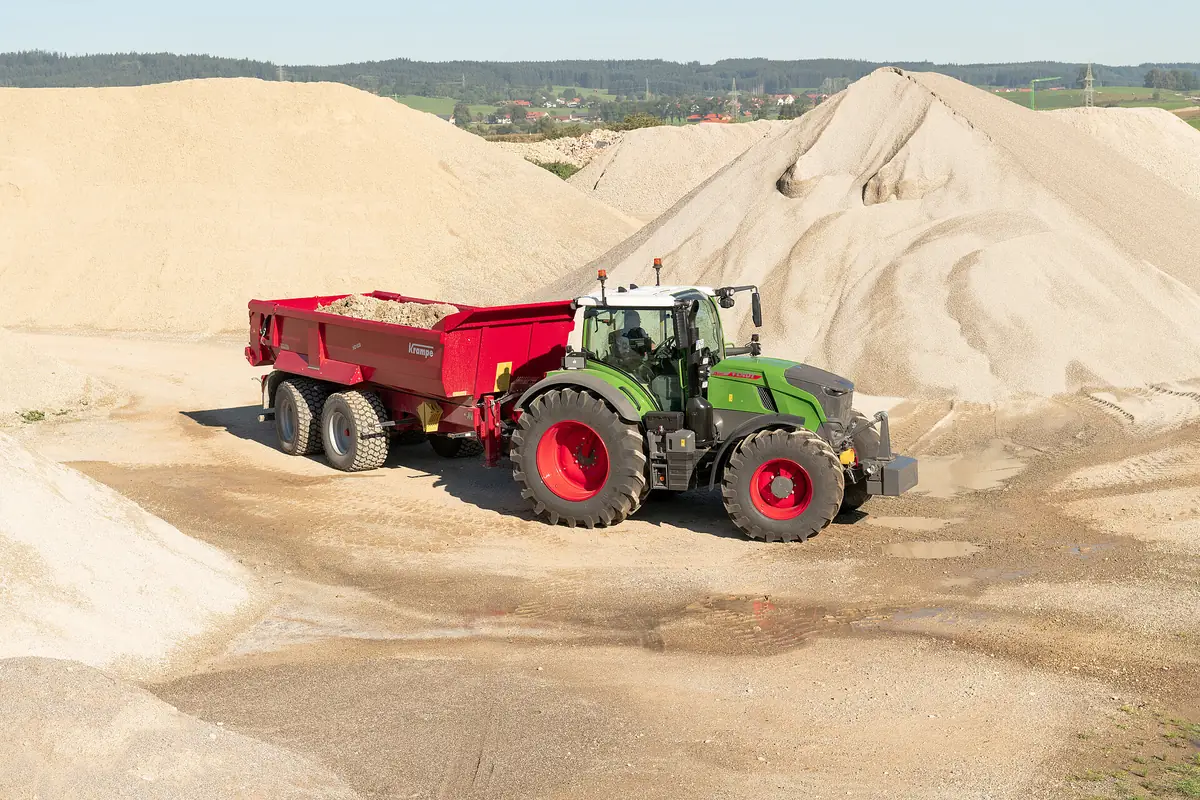 Tractor verd amb un bolquet Krampe HD 620 carregat de sorra, en una sorrera